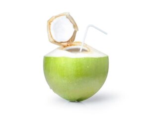 "Healthy coconut water drink poured into a clear glass"